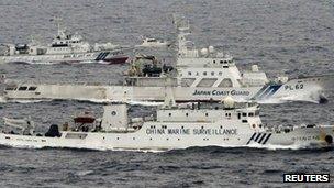 An aerial photo shows a Chinese marine surveillance ship Haijian No. 66 (C) cruising next to Japan Coast Guard patrol ships in the East China Sea, near known as Senkaku isles in Japan and Diaoyu islands in China, in this photo taken by Kyodo news agency on 23 April 2013