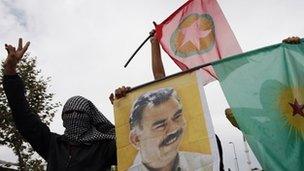 Masked demonstrators display a picture of jailed Kurdish rebel leader Abdullah Ocalan (file photo)