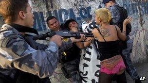 Brazilian policeman confronting protestor near Maracana stadium, 26 April 2013