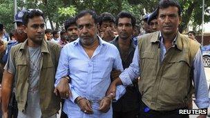 Rana Plaza owner's father, Abdul Khalek, is escorted by police