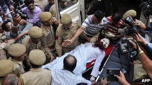 Pakistani prisoner Sanaullah, an inmate of India"s central Jammu jail that was attacked by Indian inmates at a prison, is carried from a hospital to an ambulance in Jammu on May 3, 2013, before being transferred to a hospital in Chandigarh for treatment
