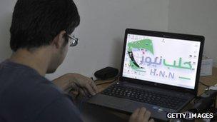 Syrian man uses laptop computer