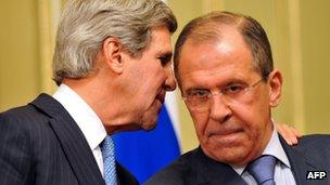US Secretary of State John Kerry whispers to Russian Foreign Secretary Sergei Lavrov