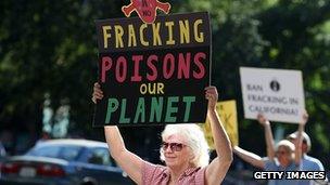 Protestors hold signs against fracking during a demonstration outside of the California Environmental Protection Agency