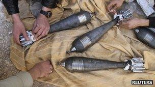Free Syrian Army fighters prepare mortar shells