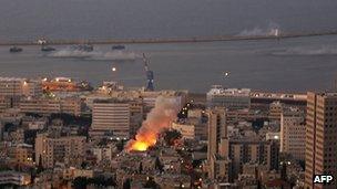 Flames are seen as a shell, one of several, slams into the city and surrounding ocean of the northern Israeli city of Haifa, 6 August 2006.