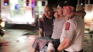 An injured man is carried to an ambulance in Granbury, Texas (15 May 2013)