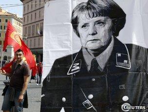 A controversial poster of German Chancellor Angela Merkel could be seen at the rally