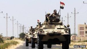 Soldiers in military vehicles proceed towards the al-Jura district in El-Arish