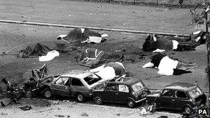 Dead horses covered up and wrecked cars at the scene of carnage in Rotten Row, Hyde Park, after an IRA bomb exploded as the Household Cavalry was passing