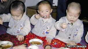 Young children eat a meal at a North Korea orphanage
