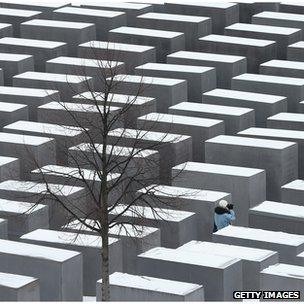 A visitor walks through the Memorial to the Murdered Jews of Europe in Berlin, Germany