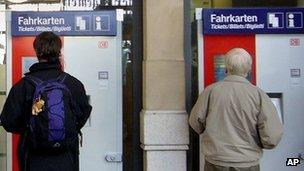 Passengers use Deutsche Bahn's ticket machines in Frankfurt