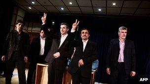 Iranian President Mahmoud Ahmadinejad and Esfandyar Rahim Mashaie make the victory sign during a press conference