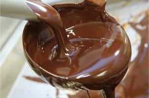 molten chocolate pouring from a ladle