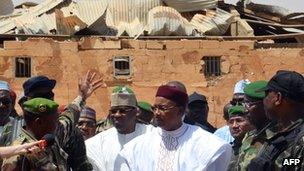 Niger's President Mahamadou Issoufou visiting in front of a damaged building in Agadez, Niger - 27 May 2013