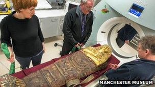 A mummy going into a CT scanner