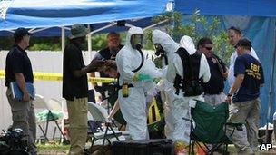 Members of an FBI hazardous materials team prepare to enter the residence in New Boston, Texas, on 31 May 2013