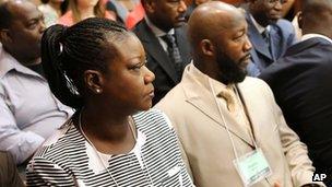 Sybrina Fulton, left, and Tracy Martin, center, parents of slain teen Trayvon Martin, sit in court on the first day of the trial 10 June 2013