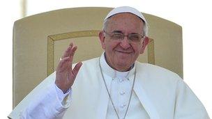 Pope Francis waves to people gathered in St Peter's Square at the Vatican on June 12, 2013