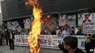 Protesters burn an effigy of North Korean leader Kim Jong-un and during an anti-North Korea rally in Seoul, South Korea, on 12 June 2013