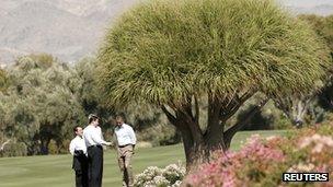 US President Barack Obama and Chinese President Xi Jinping talk as they tour the grounds at The Annenberg Retreat at Sunnylands in Rancho Mirage, California on 8 June 2013