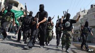 Hamas fighters carry guns and rocket propelled grenades during celebrations on the street in Rafah in June 2007