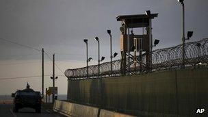 A US military vehicle patrols the perimeter of the prison at Guantanamo Bay (30 March 2010)