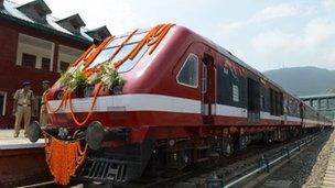 A train adorned with garlands is pictured at the platform for a flagging off ceremony attended by Indian Prime minister Manmohan Singh and Congress party President Sonia Gandhi for a train service running between Banihal and Qazigund at a station in Banihal, some 110 kms south of srinagar, on June 26, 2013.