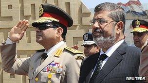 File photo of Egypt's President Morsi visiting the tomb of ex-President al-Sadat and the Tomb of the Unknown Soldier during the commemoration of Sinai Liberation Day in Cairo