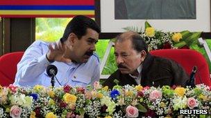 Venezuela's President Nicolas Maduro (L) speaks with Nicaragua's President Daniel Ortega