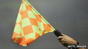 File photo of referee holding flag