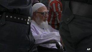 Former Jamaat-e-Islami party leader Ghulam Azam escorted to Dhaka court on 15 July 2013
