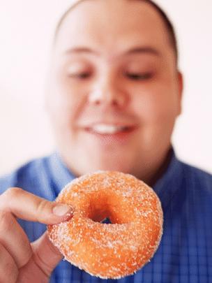 Man eyeing up a doughnut