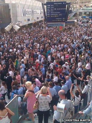Crowds of commuters waiting at Waterloo station