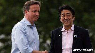 Japanese Prime Minister Shinzo Abe is greeted David Cameron at the official arrival of the G8 leaders on 17 June in Enniskillen, Northern Ireland