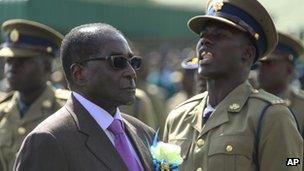 President Robert Mugabe inspects a guard of honour at a police passing-out parade in Harare, Zimbabwe on Thursday 13 June 2013