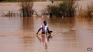 A Sudanese man wades through floodwaters in Khartoum. Photo: 3 August 2013