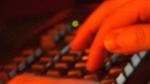 Man types on keyboard