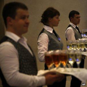Waiters hold trays of drinks ready for a reception at the Valdai forum. Photo: 19 September 2013