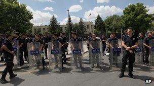Riot police stand guard outside the US embassy in Ankara, Turkey on 27 July 2013
