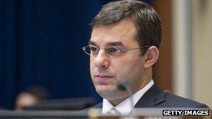 Representative Justin Amash listens during a congressional committee hearing.