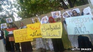Sudanese women hold placards in a protest calling for the release of prisoners held during protests