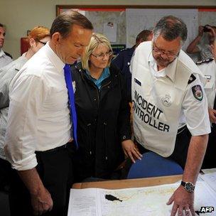 Prime Minister Tony Abbott receives a briefing at Winmalee fire station