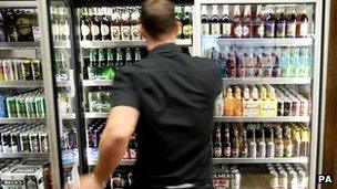 Man at fridge containing alcohol