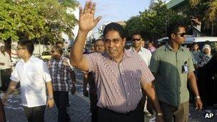 Presidential candidate Gasim Ibrahim, center, waves to supporters during an election campaign rally in Male