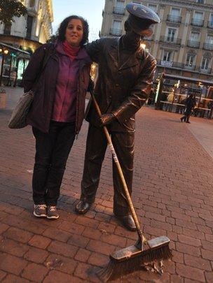 Julia Toledo and a statue of a street-sweeper in Madrid