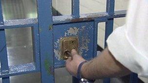 Prison officer locking gate