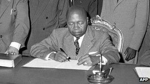 Gabonese Prime Minister and future President Leon M'ba pictured in 1960 during the signing of an agreement with France