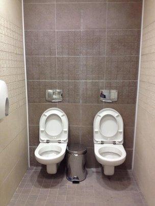 Twin toilets in a men's cubicle at Sochi's Olympic Biathlon Centre
